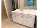 Bathroom featuring double sinks, white cabinetry, and a glass-enclosed shower at 417 Lake Butler Dr, Kissimmee, FL 34759