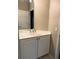Bathroom features white vanity with a sink and chrome faucet under a mirrored wall cabinet at 417 Lake Butler Dr, Kissimmee, FL 34759