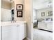 Bathroom vanity with white cabinets and view into the bedroom at 417 Lake Butler Dr, Kissimmee, FL 34759
