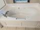 Bright bathroom featuring a large, soaking tub, perfect for relaxation at 417 Lake Butler Dr, Kissimmee, FL 34759