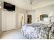 This bedroom has a television, a dresser with a mirror, and closet space at 417 Lake Butler Dr, Kissimmee, FL 34759