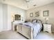 This is a well-lit bedroom with white furniture and decorative floral accents at 417 Lake Butler Dr, Kissimmee, FL 34759