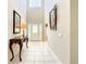 Grand foyer featuring tile floors, high ceilings, and a decorative table, leading to the home's interior at 417 Lake Butler Dr, Kissimmee, FL 34759