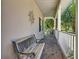 Inviting front porch with brick flooring, a decorative bench, and a glimpse of the lush landscaping beyond at 417 Lake Butler Dr, Kissimmee, FL 34759