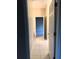 Hallway with tile flooring leads to carpeted bedroom with natural light and is newly renovated at 417 Lake Butler Dr, Kissimmee, FL 34759