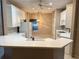 Bright kitchen features white cabinetry, a breakfast bar, and a view into the dining area at 417 Lake Butler Dr, Kissimmee, FL 34759