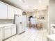 Bright eat-in kitchen features white cabinets and appliances and tile floors at 417 Lake Butler Dr, Kissimmee, FL 34759