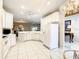 Bright and airy kitchen featuring white cabinetry, tiled floors, and ample counter space for meal preparation at 417 Lake Butler Dr, Kissimmee, FL 34759