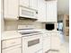 Updated kitchen features white appliances and cabinets with gold hardware at 417 Lake Butler Dr, Kissimmee, FL 34759