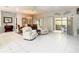 Living room with tile flooring, white furniture, and views to the lanai at 417 Lake Butler Dr, Kissimmee, FL 34759