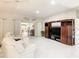 Bright and spacious living room with white furniture and tile flooring at 417 Lake Butler Dr, Kissimmee, FL 34759