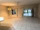 Spacious living room with tiled floors, lots of light and views of the sunroom at 417 Lake Butler Dr, Kissimmee, FL 34759
