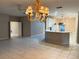 Open concept living area featuring tiled floors, chandelier, and access to the kitchen at 417 Lake Butler Dr, Kissimmee, FL 34759