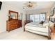 Well lit main bedroom featuring a large dresser, relaxing decor, and decorative ceiling fan at 417 Lake Butler Dr, Kissimmee, FL 34759