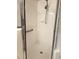 Bright white tiled shower with a glass door and chrome fixtures at 417 Lake Butler Dr, Kissimmee, FL 34759