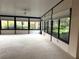 Bright sunroom with large windows offering natural light and views of the landscaped surroundings at 417 Lake Butler Dr, Kissimmee, FL 34759