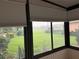 View from the sunroom of the lush green landscaping and peaceful surroundings at 417 Lake Butler Dr, Kissimmee, FL 34759