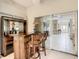 Indoor wet bar featuring wood cabinets, shelving, and stools with access to main living space at 417 Lake Butler Dr, Kissimmee, FL 34759