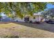 Wide view of the home's backyard with trees and lawn at 11213 Se 53Rd Ct, Belleview, FL 34420