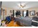 Comfortable bedroom with hardwood floors, a ceiling fan, and natural light from two windows at 11213 Se 53Rd Ct, Belleview, FL 34420