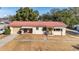 Single-story home featuring a red roof and well-maintained front lawn, showcasing its curb appeal at 11213 Se 53Rd Ct, Belleview, FL 34420