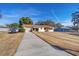 Exterior view of home with long driveway and mature trees at 11213 Se 53Rd Ct, Belleview, FL 34420