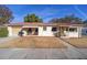 Single-story home with red roof, manicured front yard and covered front porch at 11213 Se 53Rd Ct, Belleview, FL 34420