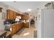 Well-lit kitchen with tiled floors, oak cabinets, and a functional layout for cooking and meal preparation at 11213 Se 53Rd Ct, Belleview, FL 34420