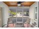 Inviting screened porch with ceiling fan and view of backyard at 11213 Se 53Rd Ct, Belleview, FL 34420