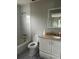 Bathroom includes a bathtub, toilet, and vanity with a mirror at 1703 Mona Ave, Ocoee, FL 34761