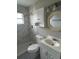 Updated bathroom with gray marble-look walls and white vanity at 1703 Mona Ave, Ocoee, FL 34761