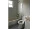 Clean bathroom with a bathtub, toilet, and gray flooring at 1703 Mona Ave, Ocoee, FL 34761