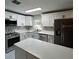 Modern kitchen with white cabinets, stainless steel appliances and an island at 1703 Mona Ave, Ocoee, FL 34761