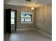 Bright living room with gray flooring and a large window at 1703 Mona Ave, Ocoee, FL 34761