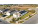 Aerial view of a modern single-Gathering home with solar panels and well-maintained landscaping at 812 Brooklet Dr, Davenport, FL 33837