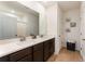 Bright bathroom featuring double sinks, a large mirror, and ample cabinet space for storage at 812 Brooklet Dr, Davenport, FL 33837