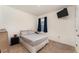 Simple bedroom with a full bed, a window with dark curtains, and a flat-screen television mounted on the wall at 812 Brooklet Dr, Davenport, FL 33837