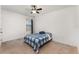 This bedroom includes neutral carpeting, a ceiling fan, and a window for natural light at 812 Brooklet Dr, Davenport, FL 33837