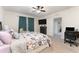 Bedroom features a ceiling fan, a dresser with a mounted TV, and a comfortable armchair at 812 Brooklet Dr, Davenport, FL 33837