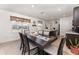 Dining area featuring a dark wood table set for six, with views into the kitchen and backyard at 812 Brooklet Dr, Davenport, FL 33837