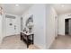 Bright entryway with neutral tile flooring, a white front door, and a stylish console table at 812 Brooklet Dr, Davenport, FL 33837