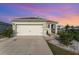 Charming one-story home featuring a two-car garage, landscaped yard, and neutral exterior paint at 812 Brooklet Dr, Davenport, FL 33837