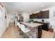 Well-lit kitchen with stainless steel appliances, tile floors, a kitchen island, and dark wood cabinets at 812 Brooklet Dr, Davenport, FL 33837