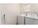 This laundry room includes a washer, a dryer, and a window at 812 Brooklet Dr, Davenport, FL 33837