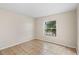 Bedroom with tile flooring, natural light from window, and neutral color walls at 536 Cheshire Way, Davenport, FL 33897