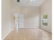 Neutral bedroom boasts tile flooring and a large window for natural light at 536 Cheshire Way, Davenport, FL 33897