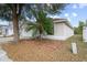 Inviting exterior of home showcasing a tidy lawn and a young palm tree at 536 Cheshire Way, Davenport, FL 33897