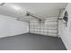 A spacious garage with a sealed concrete floor and an automatic door for secure and convenient parking at 536 Cheshire Way, Davenport, FL 33897