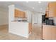Open kitchen with wooden cabinets, tile floors, and a view of the adjacent living spaces, perfect for entertaining at 536 Cheshire Way, Davenport, FL 33897