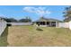 Spacious backyard with an enclosed patio, fire pit, and white vinyl fence at 1060 Colony Park Dr, Lakeland, FL 33813